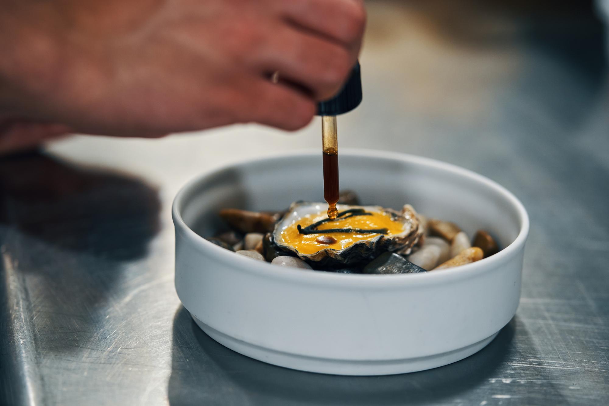 chef testing texture in small bowl